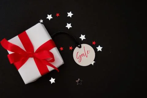 Top view of dark background with gift box and blank tag.Sale price tag. Foto stock