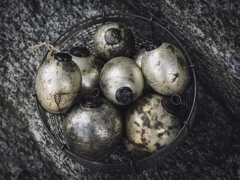 Top view of the dark colored Easter eggs in the basket with different patterns 스톡 사진
