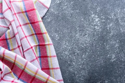 Top view dark grey background with kitchen checkered towel Stock Photos