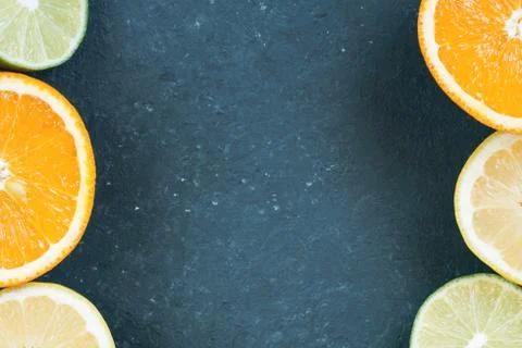 Top view of a dark table with various cut citrus. Foto stock