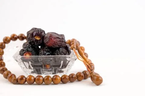 Top view of dates on glassware over white. Stock Photos