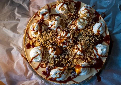 Top view of a decadent dessert featuring whipped cream dollops, drizzled ca.. Stock Photos