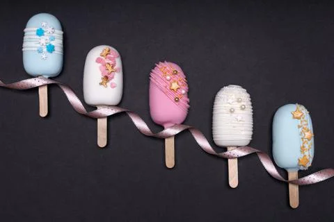 Top view of decorated cake pops ice creams on black background Stock Photos