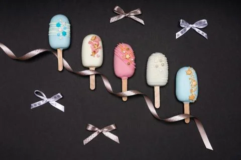 Top view of decorated cake pops ice creams on black background Stock Photos