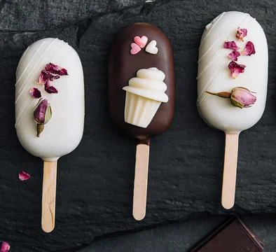 Top view of decorated cake pops ice creams on black background Stock Photos
