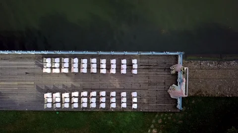 Top view of a decorated pink wedding ceremony on a wooden pier near the sea. Stock Footage 121616384