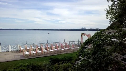 Top view of a decorated pink wedding ceremony on a wooden pier near the sea. Stock Footage 121621458