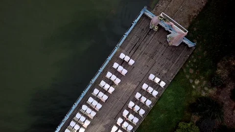 Top view of a decorated pink wedding ceremony on a wooden pier near the sea. Stock Footage 121621641