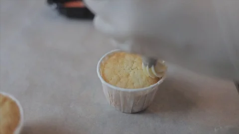 Top view of decorating of cup cake with cream and berries Stock Footage 107270931