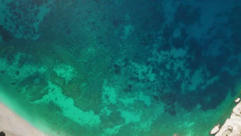 Top view of deep blue sea with coral reef patterns near coastal shore in Greece Stock Footage 342366986