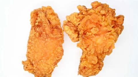 Top view deep fried chicken drumstick and wing rotating and pause Stock Footage 111511309