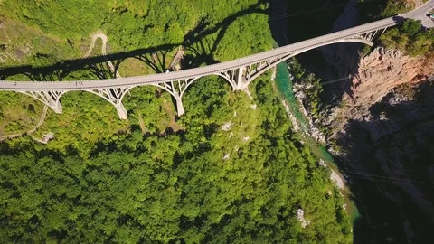 Top view of deep river canyon and Durdevica Tara arch bridge. Aerial Stock Footage 82844604