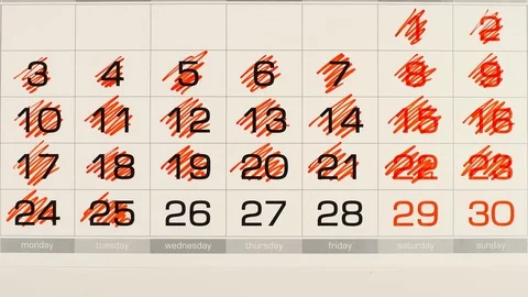 TOP VIEW: Deleting (red marker) out a numbers in a calendar - Stop motion Stock Footage 94599213