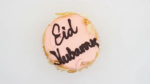 Top View Of A Delicious Eid Mubarak Cupcake, Rotating On A White Background, UK Stock Footage 154064140