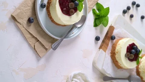 Top view of delicious mini cheesecakes served with blueberry compote and fresh b Stock Footage 343797288
