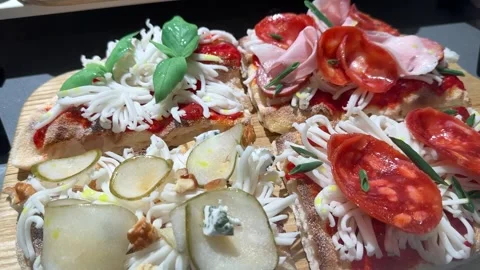 Top view of delicious sliced pizza with cheese, sausage, ham, bacon, greens Stockbeeldmateriaal 274963997