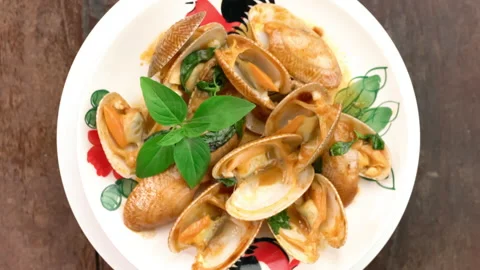 Top view of delicious stir-fried clams with roasted chilli paste and basil leaf. Stock Footage 157799799