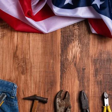 Top view design concept of Labor Day with working tools and jeans. Stock Photos