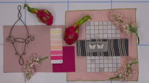 Top view of designer creating moodboard with fabric samples and flowers Stock Footage 330809418