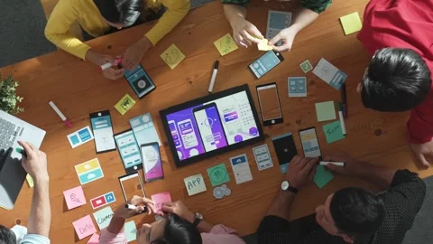 Top view designer present Ux Ui mobile phone interface at meeting. Convocation. Stock Footage 269618141