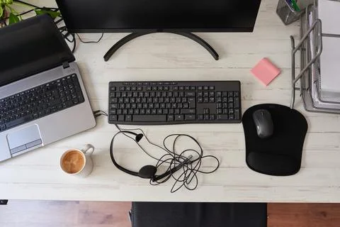Top view of a desk with computers, and headset Stock Photos