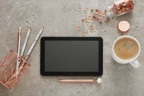 Top view of desk with empty tablet, coffee cup, pen and other accessories. Ta Stock Photos