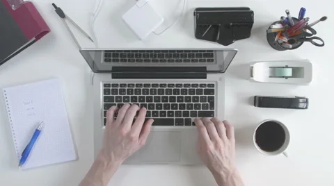 Top view of desk. Man typing on his laptop. Stock Footage 61847536