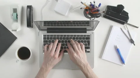 Top view of desk. Man typing on his laptop. Stock Footage 61847539