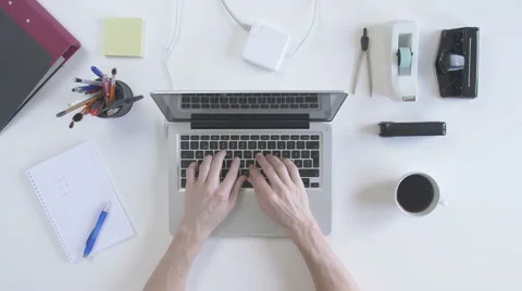 Top view of desk. Man typing on his laptop. Stock Footage 61847657