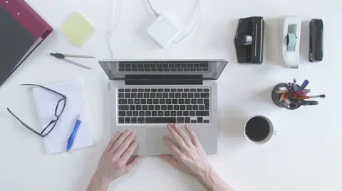 Top view of desk. Man typing on his laptop. Stock Footage 61847697