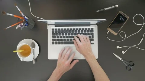 Top view of desk. Man typing on his laptop. Stock Footage 81801237