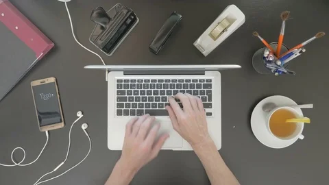 Top view of desk. Man typing on his laptop. Stock Footage 81801552