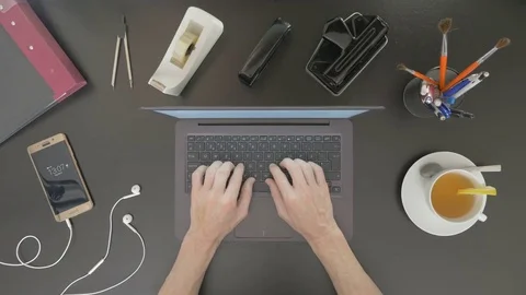 Top view of desk. Man typing on his laptop. Stock Footage 81801781