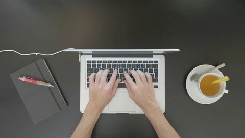 Top view of desk. Man typing on his laptop. Stock Footage 81802515
