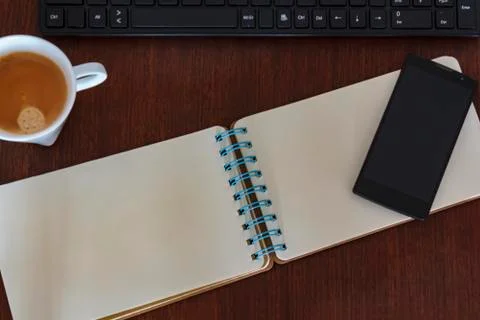 Top view of desk table with computer, notebook and coffee cup and smartphone Stock Photos