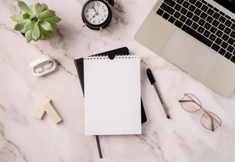 Top view desktop blank calendar, notebook and laptop on light gray marble bac Stock Photos