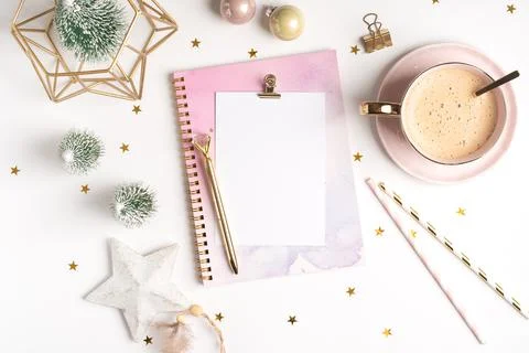 Top view of Desktop blank note pad with cup of coffee and Christmas decoration Stock Photos