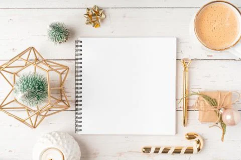 Top view Desktop Christmas notepad with mockup blank paper. Flat lay on green Stock Photos