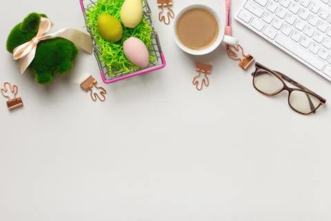 Top view of the desktop. Cup of coffee glasses keyboard with easter Stock-Fotos