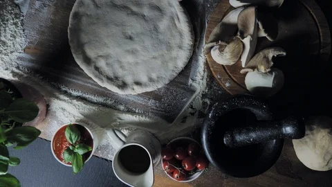 Top view of a dessert cook forming a circle for a future pizza Stock Footage 96488152