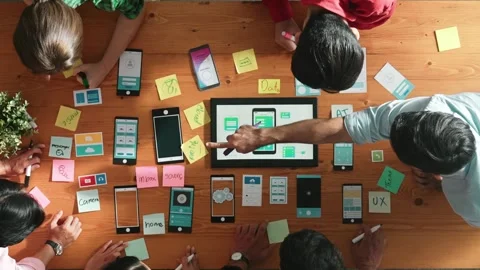 Top view of developer team working together to write idea on note. Convocation. Stock Footage 266847638