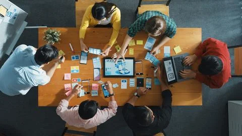 Top view of developer team working together to stick idea on board. Convocation. Stock Photos