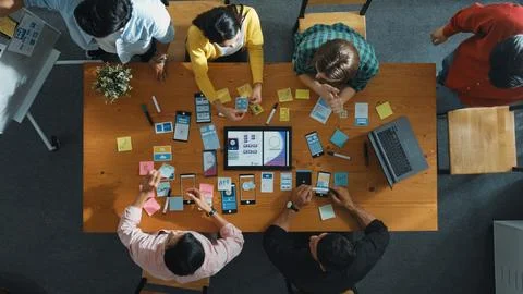 Top view of developer team working together to stick idea on board. Convocation. Stock Photos