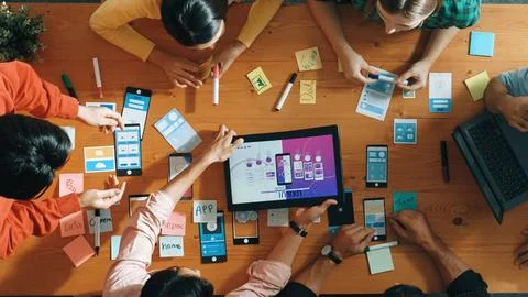 Top view of developer team working together to stick idea on board. Convocation. Stock Photos