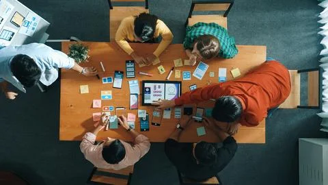 Top view of developer team working together to stick idea on board. Convocation. Stock Photos