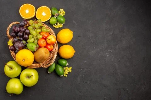 Top view different fruits composition ripe and mellow fruits on dark backgr.. Stock Photos