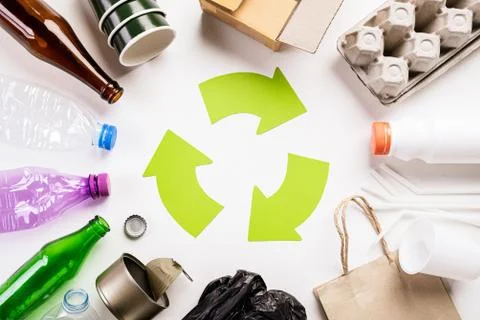 Top view of Different garbage materials with recycling symbol on white wooden Stock Photos
