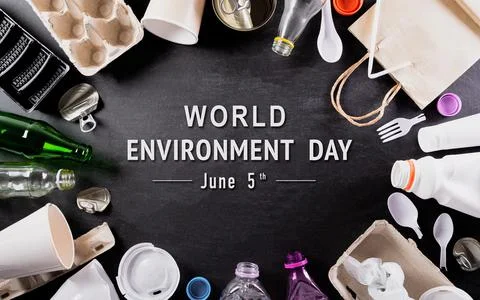 Top view of Different garbage materials with recycling symbol on black backgr Stock Photos