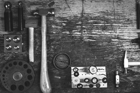 Top view of different goldsmiths tools on the jewelry workplace. Stock Photos