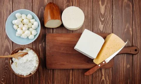 Top view of different kind of cheese on rustic wooden background Stock Photos